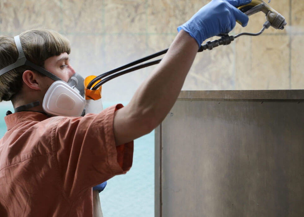 Amish Craftsman Applying a Protective Finish to Solid Wood Furniture